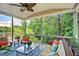 Cozy screened-in porch with comfortable seating and views of the surrounding greenery at 372 Farnleigh Dr, Chapel Hill, NC 27517