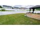 Well-maintained backyard with a lush lawn, white fence, and a stylish gazebo, ideal for outdoor relaxation at 3913 Massey Pointe Ct, Raleigh, NC 27616
