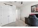 Clean home office area featuring neutral walls, a desk and chair, ceiling fan and closet at 3913 Massey Pointe Ct, Raleigh, NC 27616