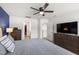 Bedroom with ceiling fan, TV on dresser, and entry to bedroom closet at 3913 Massey Pointe Ct, Raleigh, NC 27616
