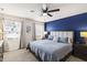 Cozy bedroom with a large bed, a blue accent wall, and two windows for natural light at 3913 Massey Pointe Ct, Raleigh, NC 27616