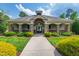 Community clubhouse featuring stone pillars, lush landscaping, and a welcoming entrance at 3913 Massey Pointe Ct, Raleigh, NC 27616
