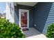 Front door with a storm door on a blue house with white trim and the house numbers visible at 3913 Massey Pointe Ct, Raleigh, NC 27616