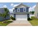 Two-story home featuring blue siding and a two-car garage, surrounded by a well-maintained lawn at 3913 Massey Pointe Ct, Raleigh, NC 27616