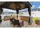 Cozy gazebo with comfortable seating and elegant decor in a private backyard, great for relaxation at 3913 Massey Pointe Ct, Raleigh, NC 27616