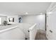 Upstairs hallway with white trim and neutral carpet and a TV mounted to the wall at 3913 Massey Pointe Ct, Raleigh, NC 27616