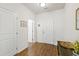 Hallway view with wood floors, white walls, and white doors, creating a clean and bright atmosphere at 3913 Massey Pointe Ct, Raleigh, NC 27616