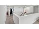 Second floor hallway featuring neutral walls and carpet, access to a bathroom, and an office area at 3913 Massey Pointe Ct, Raleigh, NC 27616