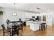 Bright kitchen features an island with granite countertops, white cabinets, and stainless steel appliances at 3913 Massey Pointe Ct, Raleigh, NC 27616
