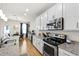 Bright kitchen boasts stainless steel appliances, granite countertops, and eat in dining area at 3913 Massey Pointe Ct, Raleigh, NC 27616