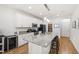 Kitchen with granite countertops, white cabinets, stainless appliances, and spacious island at 3913 Massey Pointe Ct, Raleigh, NC 27616