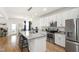 Open concept kitchen featuring an island with seating, granite countertops, and stainless steel appliances at 3913 Massey Pointe Ct, Raleigh, NC 27616