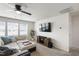 Relaxing living room with a ceiling fan, mounted TV, and a large sectional sofa at 3913 Massey Pointe Ct, Raleigh, NC 27616