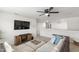 Cozy upstairs living room with ceiling fan, neutral walls, mounted TV and comfortable seating at 3913 Massey Pointe Ct, Raleigh, NC 27616