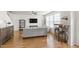 Open living room features a modern sectional sofa, large windows, and hardwood floors at 3913 Massey Pointe Ct, Raleigh, NC 27616