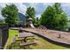 Neighborhood playground with slides, climbing features, and seating at 3913 Massey Pointe Ct, Raleigh, NC 27616