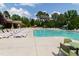 Large community pool with lounge chairs under a sunny sky, surrounded by mature trees at 3913 Massey Pointe Ct, Raleigh, NC 27616