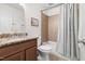 Bathroom features a tub/shower combo with tile surround and a granite-topped vanity with updated fixtures at 407 Sparella St, Durham, NC 27703