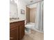 Bathroom features a tub/shower combo with tile surround and a granite-topped vanity with updated fixtures at 407 Sparella St, Durham, NC 27703