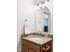 Bathroom with a granite-topped vanity, brushed nickel fixtures, and an arched mirror with decorative lighting at 407 Sparella St, Durham, NC 27703