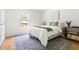 Bright bedroom with a large window, stylish rug, and a curated mix of modern and vintage decor at 407 Sparella St, Durham, NC 27703