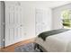 Bright bedroom with hardwood floors, a double closet, and a large window overlooking a green lawn at 407 Sparella St, Durham, NC 27703