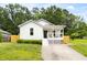 Charming single-story home featuring a welcoming front porch, landscaped yard, and a well-maintained lawn at 407 Sparella St, Durham, NC 27703