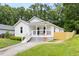 Quaint single-story house with a welcoming porch and well-maintained landscaping and a defined walkway at 407 Sparella St, Durham, NC 27703