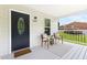Cozy front porch featuring seating, a stylish door, and an inviting entrance, all under a covered area at 407 Sparella St, Durham, NC 27703