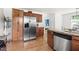 Kitchen boasts stainless steel appliances, hardwood floors, granite countertops, and ample cabinet space at 407 Sparella St, Durham, NC 27703