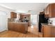A bright kitchen with wooden cabinets, granite countertops, tile backsplash, and hardwood floors at 407 Sparella St, Durham, NC 27703