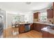 Open kitchen featuring wood cabinets, granite countertops, stainless steel appliances, and hardwood flooring at 407 Sparella St, Durham, NC 27703