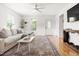 Bright living room features hardwood floors, neutral walls, a large sofa, and natural light at 407 Sparella St, Durham, NC 27703
