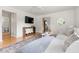 Bright living room featuring hardwood floors, a large sectional sofa, a TV, and an open layout at 407 Sparella St, Durham, NC 27703