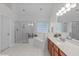 Bright bathroom featuring a glass-enclosed shower, soaking tub, and dual vanities at 408 Dairy Farm Dr, Hillsborough, NC 27278