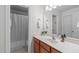 Well-lit bathroom featuring a sink with cabinet, mirror, and shower with curtain at 408 Dairy Farm Dr, Hillsborough, NC 27278