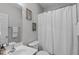 Clean bathroom with a white vanity, a toilet, a shower with curtain, and decorative wall art at 408 Dairy Farm Dr, Hillsborough, NC 27278