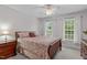 Comfortable bedroom with ceiling fan, natural light, and coordinating furnishings at 408 Dairy Farm Dr, Hillsborough, NC 27278