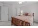 Well-lit bedroom features a bed, ceiling fan, and two entry doors at 408 Dairy Farm Dr, Hillsborough, NC 27278
