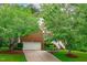 Charming brick home with a well-manicured lawn, mature trees, and a two-car garage at 408 Dairy Farm Dr, Hillsborough, NC 27278