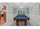 Well-lit game room with a blue felt pool table and neutral-toned walls at 408 Dairy Farm Dr, Hillsborough, NC 27278