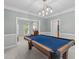 Bright game room featuring a blue felt pool table under an industrial-style light fixture and views to other rooms at 408 Dairy Farm Dr, Hillsborough, NC 27278