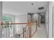 Hallway with staircase featuring wooden handrails and a large arched window overlooking the entry at 408 Dairy Farm Dr, Hillsborough, NC 27278
