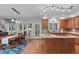 Open-concept kitchen and dining area with hardwood floors, a kitchen island, and direct access to the backyard at 408 Dairy Farm Dr, Hillsborough, NC 27278