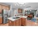 Well-appointed kitchen with stainless steel refrigerator, kitchen island, electric stovetop, and seating at the dining table at 408 Dairy Farm Dr, Hillsborough, NC 27278