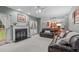 Inviting living room with a cozy fireplace, plush seating, and an open floor plan at 408 Dairy Farm Dr, Hillsborough, NC 27278