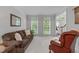 Comfortable living room with plush seating, large windows, and neutral color scheme at 408 Dairy Farm Dr, Hillsborough, NC 27278