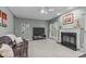 Cozy living room featuring a fireplace, plush seating, and a sliding glass door leading to the exterior at 408 Dairy Farm Dr, Hillsborough, NC 27278
