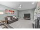 Comfortable living room with a fireplace, leather sofas, a ceiling fan, and neutral-toned decor at 408 Dairy Farm Dr, Hillsborough, NC 27278