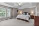 Serene main bedroom with a tray ceiling, neutral color palette, and natural light at 408 Dairy Farm Dr, Hillsborough, NC 27278